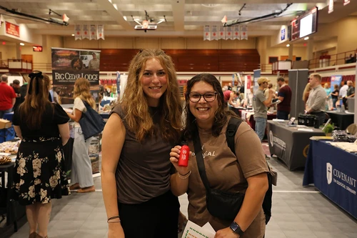 two women smiling at camera at career expo